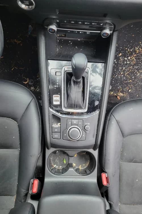 Mazda CX-5 center console with crumbs and debris before detailing