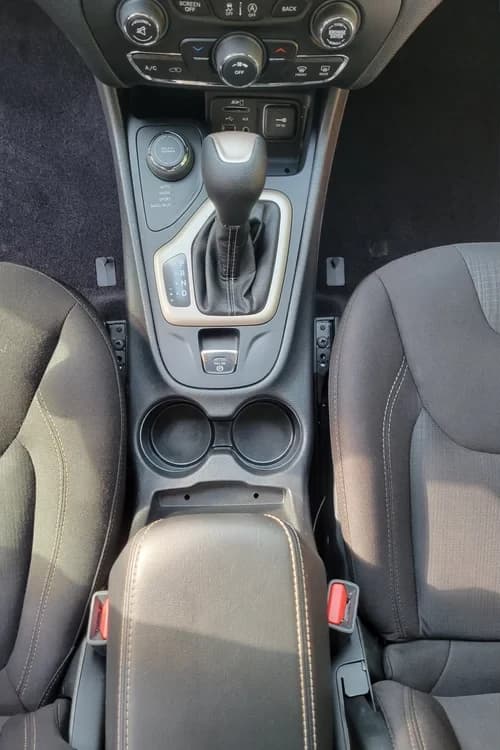 Same Jeep center console and cupholders clean after detailing