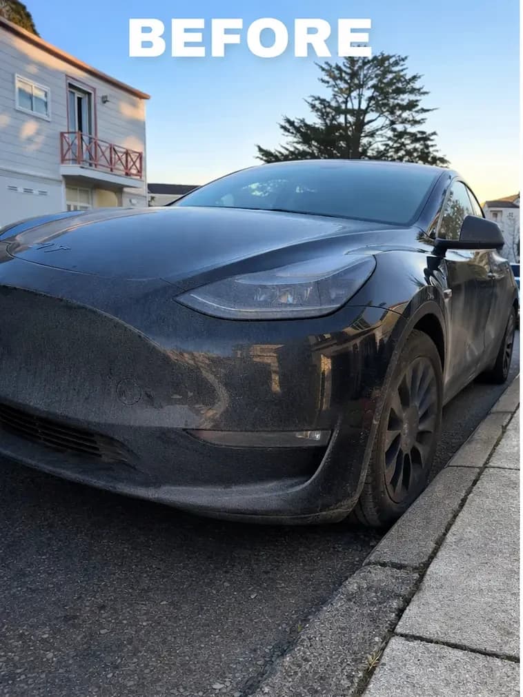 Black Tesla crossover covered with road film before exterior detailing